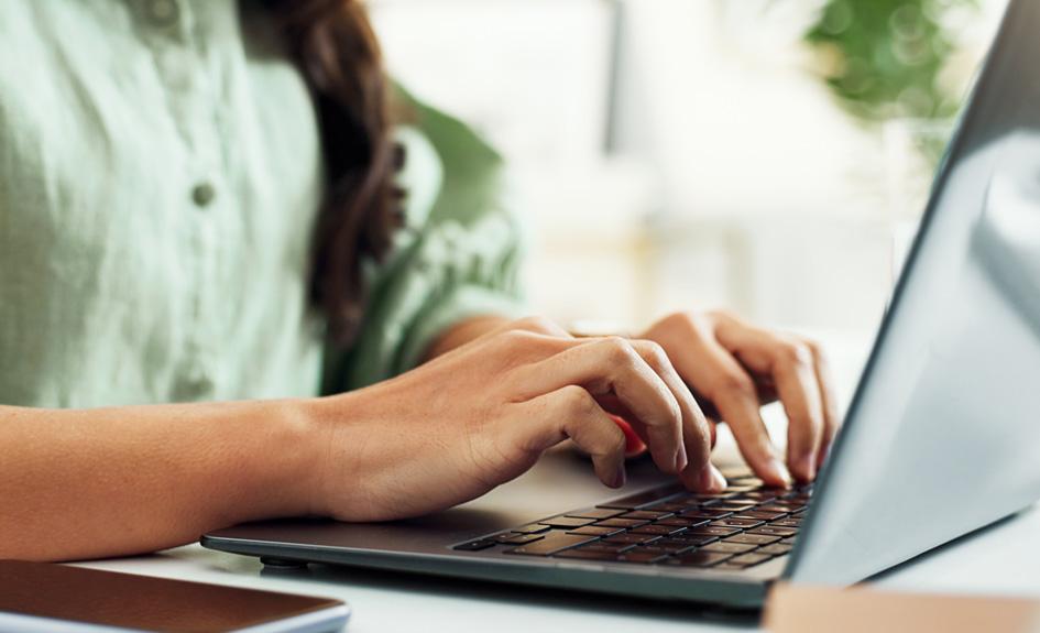 Decorative image of a hands typing on a laptop.